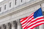 USA national flag waving in the wind in front of United States Court House in New York