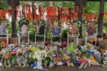 Highland Park^ IL July 16^ 2022^ memorial to the High Park parade shooting victims with their photos and flower bouquets^ mass shooting