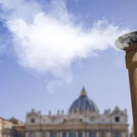 Vatican City - 04-25-2025: White smoke from the chimney on top of the Sistine Chapel. It indicates that the Pope has been elected.