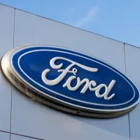 Closeup of the Ford logo seen at a Ford dealership store in Sunnyvale^ California. Ford Motor Company is an American multinational automobile manufacturer. Sunnyvale^ CA^ USA - Nov 22^ 2023