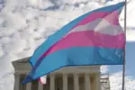 A transgender pride flag flies in front of the U.S. Supreme Court building in Washington^ DC.