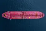 Aerial view crude oil tanker ship at sea^ Red crude oil tanker ship top view^ Logistic and maritime transpoprtation of petroleum^ Modern offshore terminal loading tanker ship.