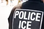 Ice police agent - Officer of Immigration and Customs Enforcement. Close up of POLICE ICE on back of stab proof vest worn by DHS Department of Homeland Security police officer at the scene of incident