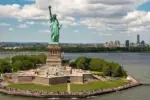 New York City with statue of liberty photo from drone. Aerial view of statue of liberty skyline in Manhattan. NYC^ NY. Cityscape near statue of liberty. Famous statue of liberty of New York.