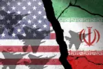 Flag of USA and Iran painted on a concrete wall with airplane shadows