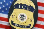 US ICE Officer badge on United States of America flag close up