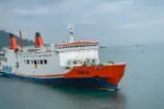 Merak^ 22 February 2026 Passenger ferry crossing the Sunda Strait connecting Java and Sumatra^ featuring large roll-on roll-off vessels operating between Merak and Bakauheni under a cloudy sky.