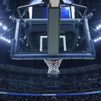 Brightly lit Basketball backboard in a large sports arena.