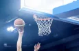 Ball in hoop at basketball game. Athletic competitions and games concept.