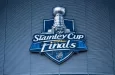the front facade of a hockey arena with the NHL Stanley Cup Finals logo on the front of the building.