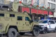 City police^ state police and Homeland Security officers^ and an armored vehicle and state patrol vehicle on Canal Street near the entrance to Bourbon Street New Orleans^ LA^ USA - January 2^ 2025