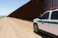 Police car stopped near the border fence of the USA . Arizona^ USA - June 28^ 2016