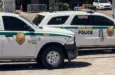 Two Miami-Dade police K-9 cars are parked near a metal security fence on a bright sunny day. Miami^ Florida^ USA^ June 16th 2025