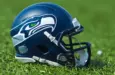 NFL Seattle Seahawks replica helmet on artificial grass playing turf ^ product shot