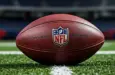 Outdoor photo of nfl ball in the middle of the football field