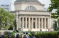 Students at the Columbia University campus on the Upper West Side of Manhattan. Steps of the Low Memorial Library in the background. New York^ NY^ USA - July 8^ 2022: