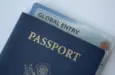 Global Entry card (Trusted traveller) covered of Passport of United states on white background.