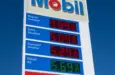 Mobil gas station sign showing high price of California Gasoline with bright blue sky Lone Pine^ CA^ USA - February 9th^ 2023