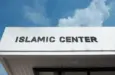 Islamic Center sign on a community building under blue sky^ symbolizing worship^ cultural education^ Muslim community services^ faith^ and spiritual guidance