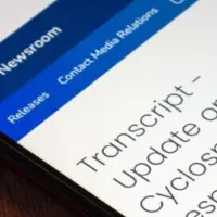 Mexico City^ MEXICO - Jul 21 2026 : Close-up of a smartphone on a wooden surface showing the CDC Newsroom webpage with a transcript titled Update on CDC's Cyclosporiasis Response.