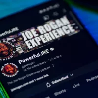 Joe Rogan experience podcast on smartphone screen.