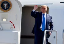 President Donald Trump waves as he steps off Air Force One at John Wayne Airport^ Santa Ana^ Calif.^ on Sunday Oct. 18^ 2020.