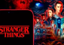 Computer keyboard with the Iphone 11 pro with the Stranger Things logo.