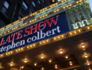 Manhattan NYC buildings in Times Square^ Broadway street avenue road^ signs for Stephen Colbert Late Show- Marquee / Theatre at Night