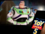 New Disney film Toy Story 5. A man's hand holds a phone with a poster of the new cartoon Toy Story 5 by Pixar. Moscow November 2025.