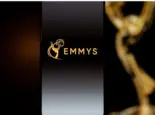 Emmys logo displayed on a smartphone screen with a blurred gold award statuette in the background^ television industry awards and digital streaming concept. Kaunas^ Lithuania - 2026 March 24