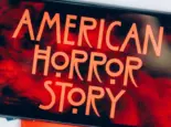 Screensaver with the 'American horror story' logo on a smartphone on toned background