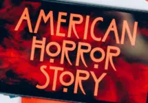 Screensaver with the 'American horror story' logo on a smartphone on toned background