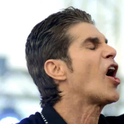 singer Perry Farrell performs at an outdoor concert in Indiana.