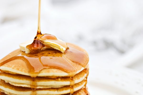 maple-syrup-pouring-onto-pancakes