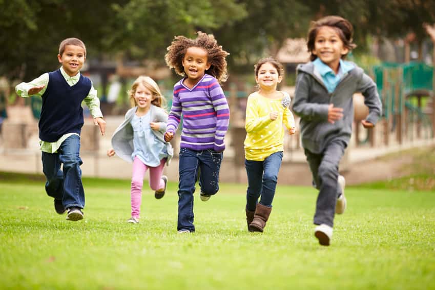 group-of-young-children-running-towards-camera-in-park