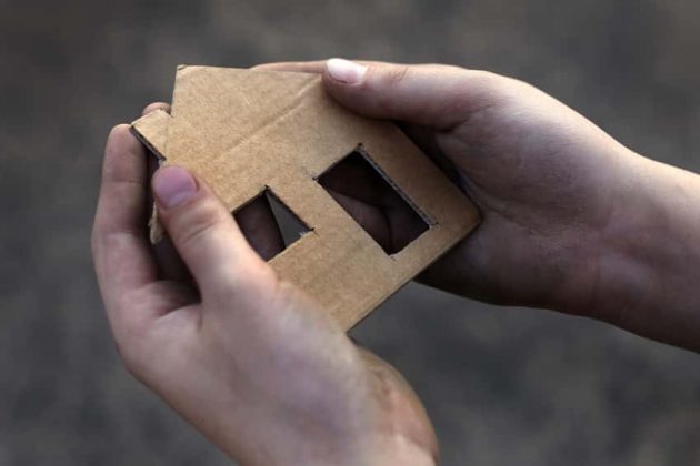 homeless-boy-holding-a-cardboard-house