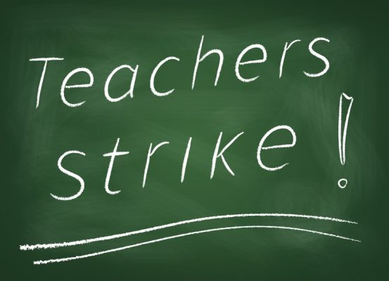 the-school-board-on-which-is-written-in-chalk-teachers-strike