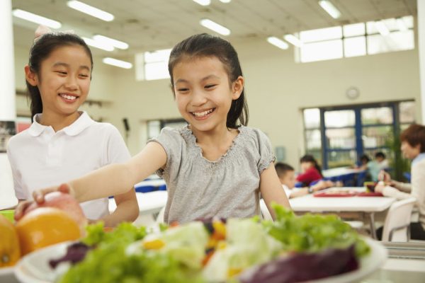 35992525-students-reaching-for-healthy-food-in-school-cafeteria