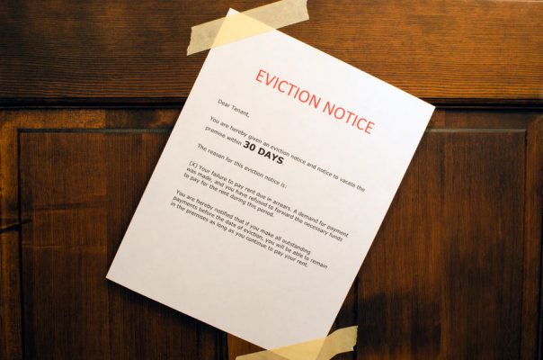 26790815-an-eviction-notice-taped-to-a-door
