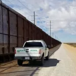 U.S. Customs and Border Patrol vehicle drives along the U.S.-Mexico border. El Paso^ Texas / USA - March 7^ 2020