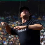 New York Yankees' Gerrit Cole throws a foul ball over the net into the stands during a game against Oakland Athletics at RingCentral Coliseum. Oakland^ California - August 28^ 2021