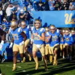 UCLA players run onto the field before an NCAA college football game between the UCLA and the Arizona State^ Nov. 11^ 2023^ in Pasadena^ Calif.