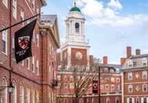 View of the architecture of the famous Harvard University in Cambridge^ Massachusetts^ USA showcasing it brick buildings with some students and locals passing by . Cambridge^ MA^ USA - March 15^ 2024