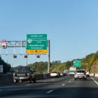 Highway i-95 interstate road in Virginia with cars on commute in morning traffic near Washington DC and sign for Prince William Parkway and ManassasWoodbridge^ USA - October 18^ 2021:
