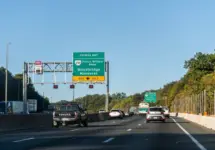 Highway i-95 interstate road in Virginia with cars on commute in morning traffic near Washington DC and sign for Prince William Parkway and ManassasWoodbridge^ USA - October 18^ 2021: