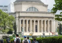 Students at the Columbia University campus on the Upper West Side of Manhattan. Steps of the Low Memorial Library in the background. New York^ NY^ USA - July 8^ 2022: