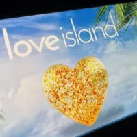'2025 Love Island'' shown on a smart phone. is a reality dating show that originated in the UK. The premise involves a group of singles living together in a luxurious villa^ where they couple up Toronto^ Canada - June 5
