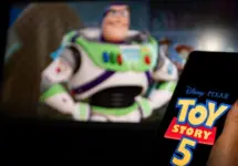 New Disney film Toy Story 5. A man's hand holds a phone with a poster of the new cartoon Toy Story 5 by Pixar. Moscow November 2025.