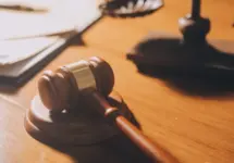 law books and scales of justice on desk in library of law firm. jurisprudence legal education concept.