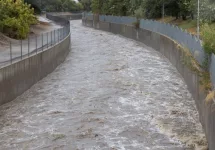 A high Los Angeles River rushes under Sepulveda Boulevard during flash flooding. August 20^2023